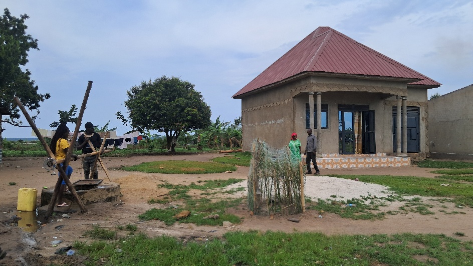 Edith, Caleb, and neighbors at a community water well